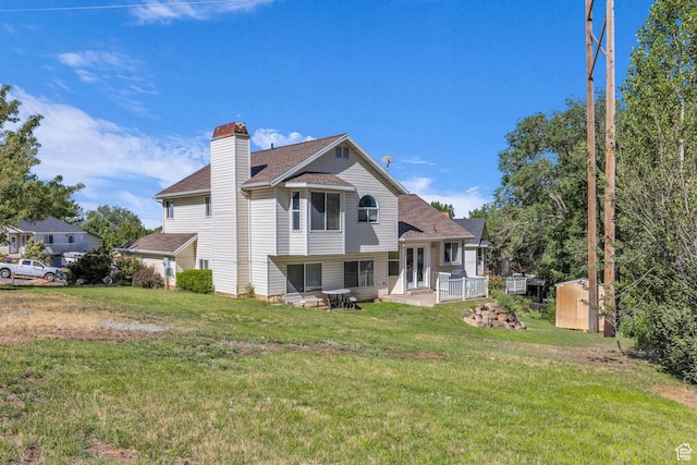 1156 E Avalon Hills Dr N, Ogden, UT 84404 - back of property featuring a shed, a lawn, a chimney, and a shingled roof