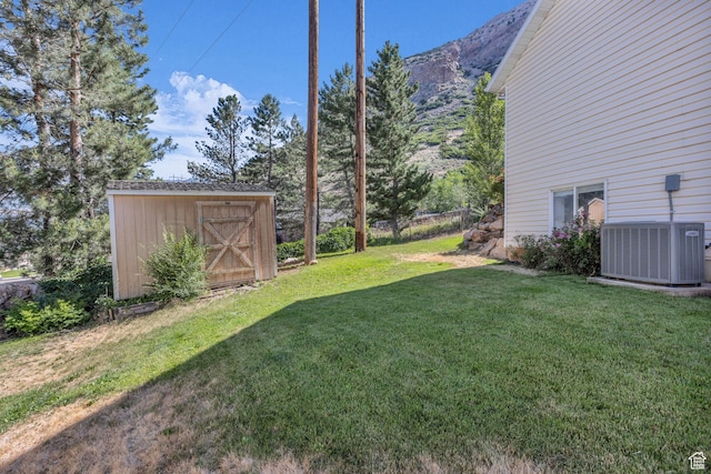 1156 E Avalon Hills Dr N, Ogden, UT 84404 - view of grassy yard with a storage unit and a mountain view