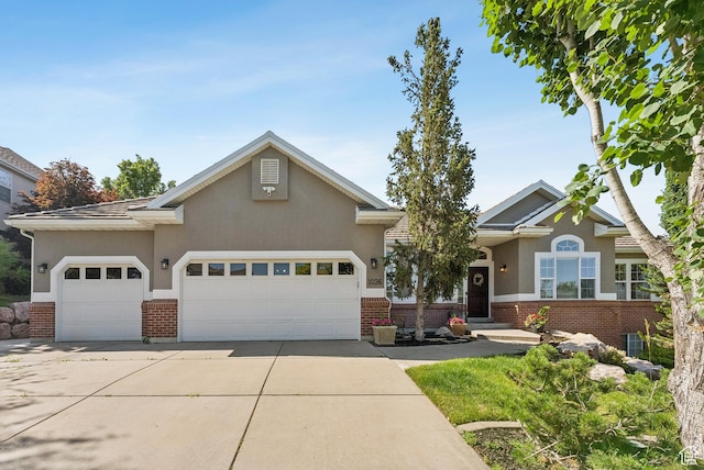 1036 E Fairway Dr, North Salt Lake, UT 84054 - view of front facade with brick siding, an attached garage, driveway, and stucco siding