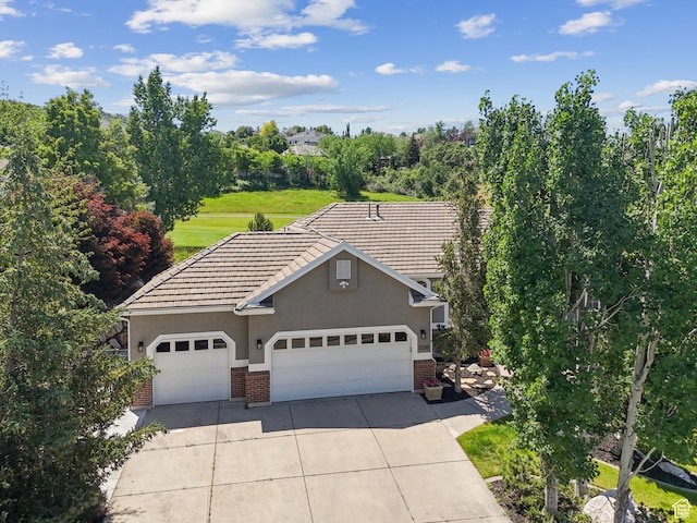 1036 E Fairway Dr, North Salt Lake, UT 84054 - view of front facade with brick siding, driveway, stucco siding, a garage, and a tile roof