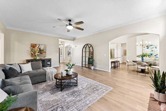 1036 E Fairway Dr, North Salt Lake, UT 84054 - living room featuring arched walkways, a ceiling fan, light wood-type flooring, a chandelier, and ornamental molding