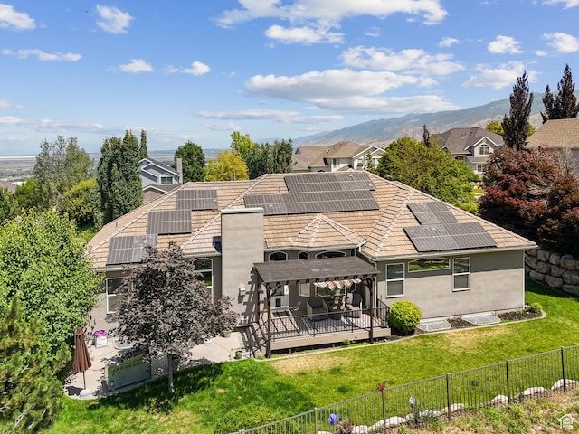 1036 E Fairway Dr, North Salt Lake, UT 84054 - rear view of property featuring a fenced backyard, a deck with mountain view, and roof mounted solar panels