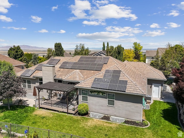 1036 E Fairway Dr, North Salt Lake, UT 84054 - rear view of property featuring roof mounted solar panels, stucco siding, a deck, and a tile roof