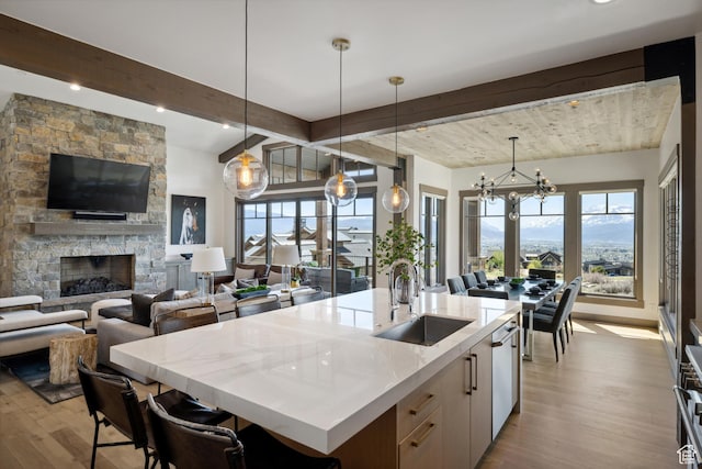 1467 N Chimney Rock Rd, Heber City, UT 84032 - kitchen featuring wood finished floors, beam ceiling, plenty of natural light, a center island with sink, and open floor plan