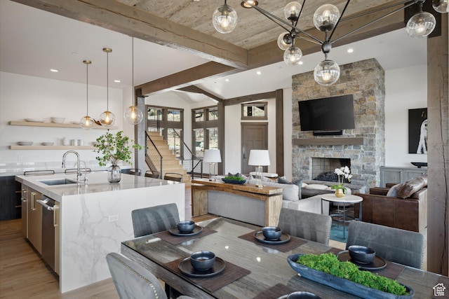 1467 N Chimney Rock Rd, Heber City, UT 84032 - dining room featuring light wood-style floors, beam ceiling, a stone fireplace, stairway, and recessed lighting