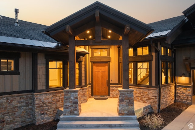 1467 N Chimney Rock Rd, Heber City, UT 84032 - exterior entry at dusk with stone siding and roof with shingles