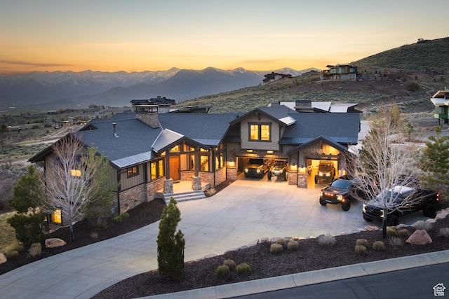 1467 N Chimney Rock Rd, Heber City, UT 84032 - view of front of property featuring stone siding, a mountain view, an attached garage, and driveway
