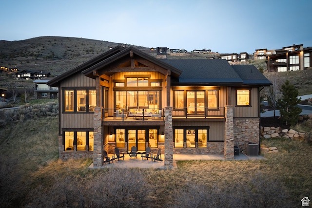 1467 N Chimney Rock Rd, Heber City, UT 84032 - rear view of property featuring a patio area, stone siding, a mountain view, and board and batten siding
