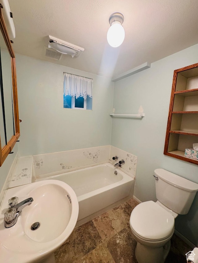 230 E 300 S, Ephraim, UT 84627 - bathroom featuring a garden tub, stone finish floors, and a textured ceiling