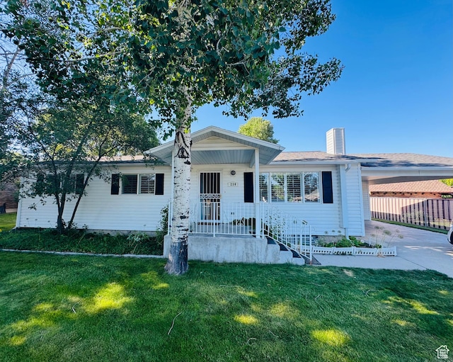 230 E 300 S, Ephraim, UT 84627 - view of front facade featuring a front yard, driveway, a chimney, and a carport