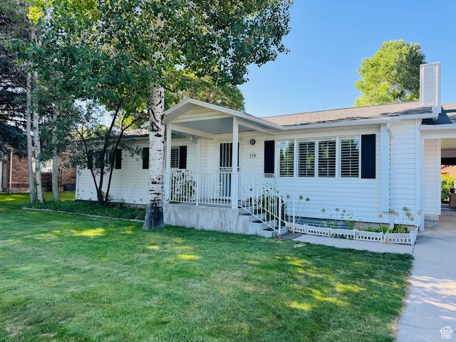 230 E 300 S, Ephraim, UT 84627 - view of front of home with a front yard, a porch, an attached carport, driveway, and a chimney