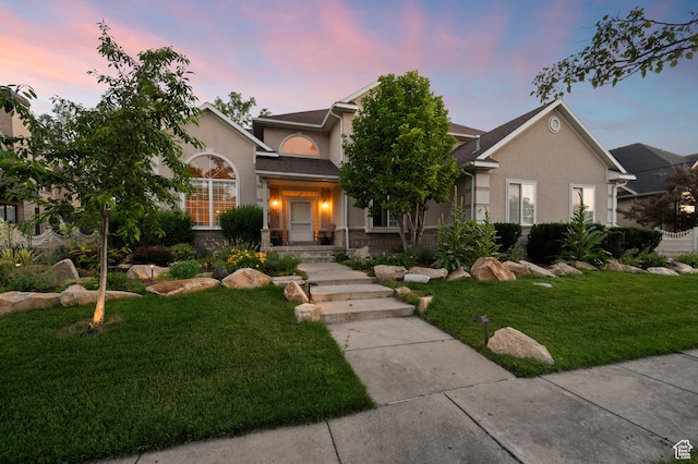 5864 Majestic Pine Dr, Murray, UT 84107 - view of front of home featuring stucco siding, a front yard, and stone siding