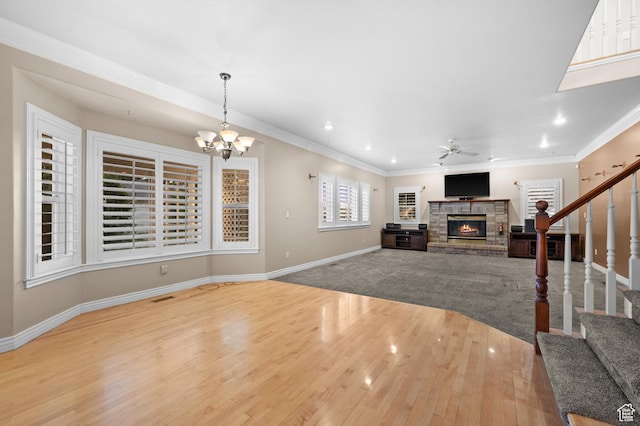 5864 Majestic Pine Dr, Murray, UT 84107 - living area with a fireplace, wood finished floors, stairway, ceiling fan, and a chandelier