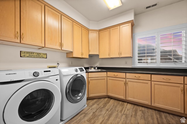 5864 Majestic Pine Dr, Murray, UT 84107 - washroom featuring independent washer and dryer, light wood-style floors, and cabinet space