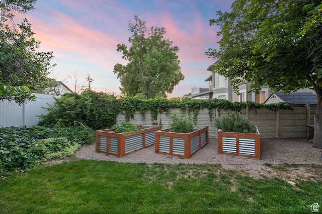 5864 Majestic Pine Dr, Murray, UT 84107 - yard at dusk with a vegetable garden and a fenced backyard