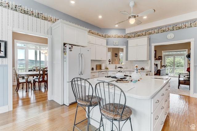 30455 N 11000 E, Fairview, UT 84629 - kitchen with white appliances, a center island, light countertops, a ceiling fan, and a kitchen bar