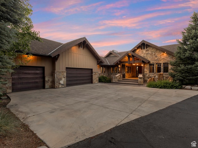 3327 E Wasatch Pines Ln, Sandy, UT 84092 - view of front of home with stone siding, a garage, concrete driveway, a porch, and board and batten siding