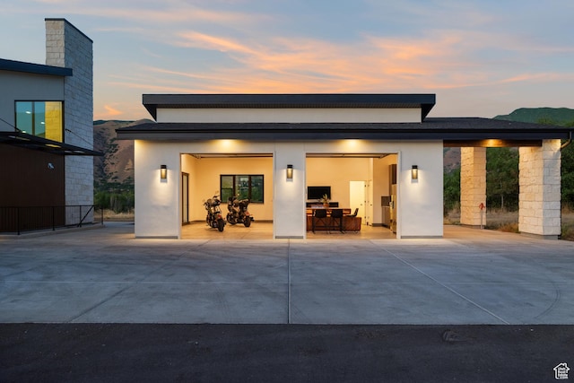 1882 N Main St, Mapleton, UT 84664 - rear view of house with concrete driveway, an attached garage, and stucco siding
