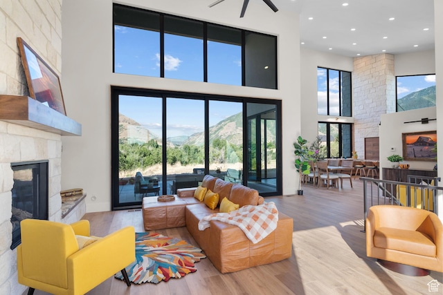 1882 N Main St, Mapleton, UT 84664 - living area with a high ceiling, a glass covered fireplace, wood finished floors, recessed lighting, and ceiling fan