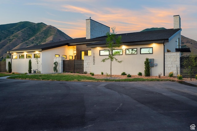 1882 N Main St, Mapleton, UT 84664 - contemporary house with a chimney, stucco siding, and a mountain view