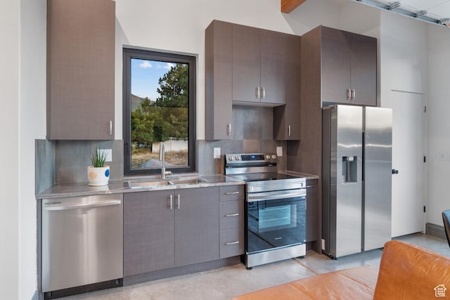 1882 N Main St, Mapleton, UT 84664 - kitchen featuring appliances with stainless steel finishes, decorative backsplash, gray cabinets, and light stone counters