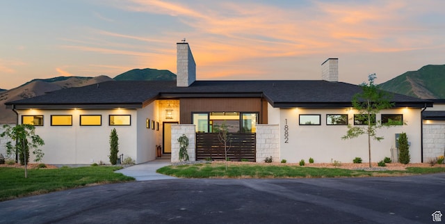 1882 N Main St, Mapleton, UT 84664 - view of front facade with a chimney, a mountain view, and stucco siding