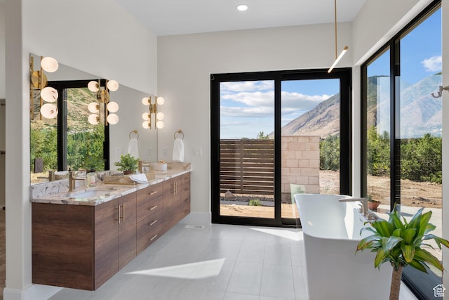 1882 N Main St, Mapleton, UT 84664 - full bathroom featuring a freestanding bath, a mountain view, double vanity, and tile patterned flooring