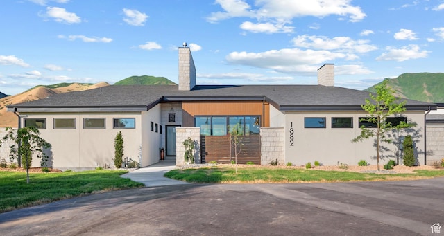 1882 N Main St, Mapleton, UT 84664 - view of front of home featuring a chimney, a mountain view, and stucco siding