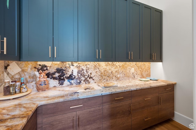 1882 N Main St, Mapleton, UT 84664 - kitchen with blue cabinets, tasteful backsplash, light stone countertops, and wood finished floors