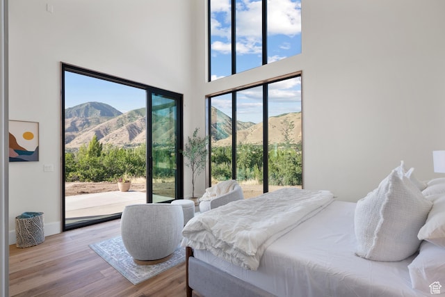 1882 N Main St, Mapleton, UT 84664 - bedroom featuring access to exterior, wood finished floors, a mountain view, and a towering ceiling