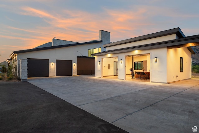 1882 N Main St, Mapleton, UT 84664 - view of front of house featuring an attached garage, concrete driveway, stucco siding, and a chimney