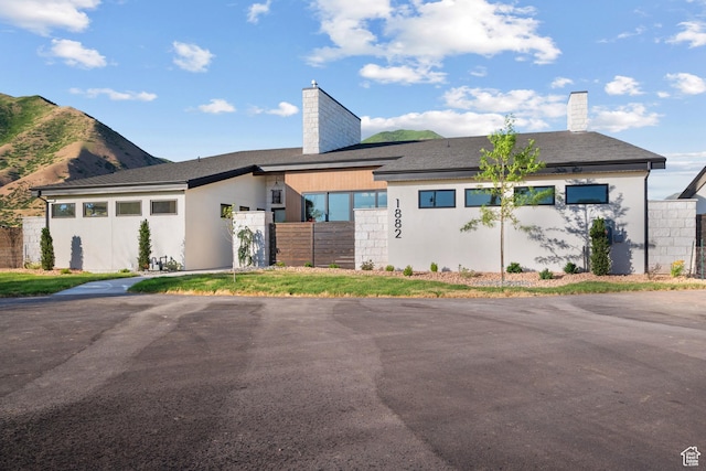 1882 N Main St, Mapleton, UT 84664 - view of front facade featuring a chimney, stucco siding, and a mountain view