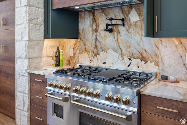 1882 N Main St, Mapleton, UT 84664 - kitchen with range with two ovens, decorative backsplash, custom exhaust hood, and light stone countertops