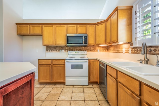 192 N 690 E, Tooele, UT 84074 - kitchen with stainless steel appliances, brown cabinetry, decorative backsplash, and light countertops