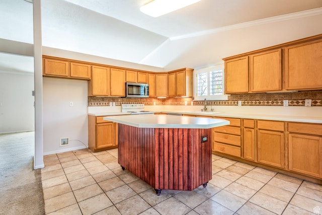192 N 690 E, Tooele, UT 84074 - kitchen featuring stainless steel microwave, electric range, tasteful backsplash, a kitchen island, and light countertops