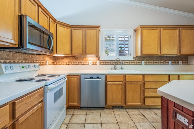 192 N 690 E, Tooele, UT 84074 - kitchen featuring appliances with stainless steel finishes, lofted ceiling, tasteful backsplash, crown molding, and light countertops