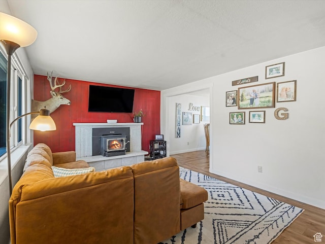 155 Hawthorne, Kamas, UT 84036 - living area with wood finished floors, a fireplace, wooden walls, and an accent wall