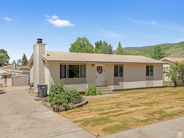 155 Hawthorne, Kamas, UT 84036 - view of front of property featuring a chimney, a mountain view, a front yard, and a shingled roof