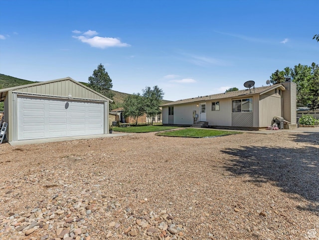 155 Hawthorne, Kamas, UT 84036 - back of house featuring an outbuilding, a garage, and a chimney