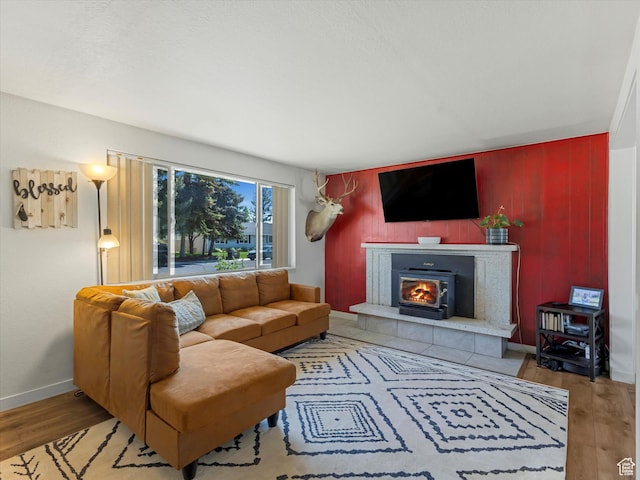 155 Hawthorne, Kamas, UT 84036 - living area with wood finished floors, a fireplace, an accent wall, and wood walls