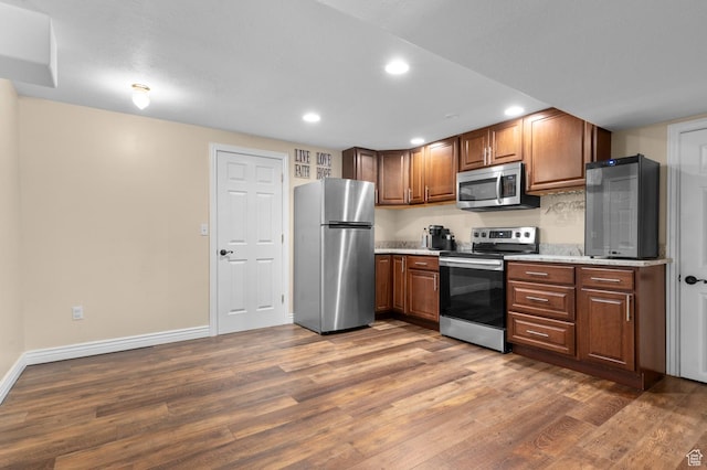 352 E Maple Dr, Alpine, UT 84004 - kitchen featuring appliances with stainless steel finishes, wood finished floors, recessed lighting, and brown cabinetry