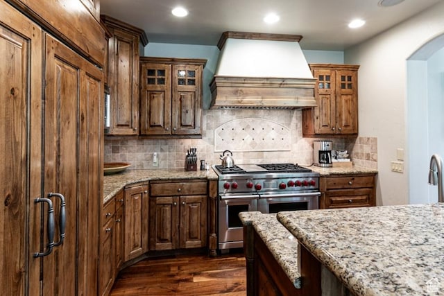 8789 Marsac Ave Unit 4, Park City, UT 84060 - kitchen featuring range with two ovens, custom exhaust hood, dark wood-style floors, light stone countertops, and recessed lighting