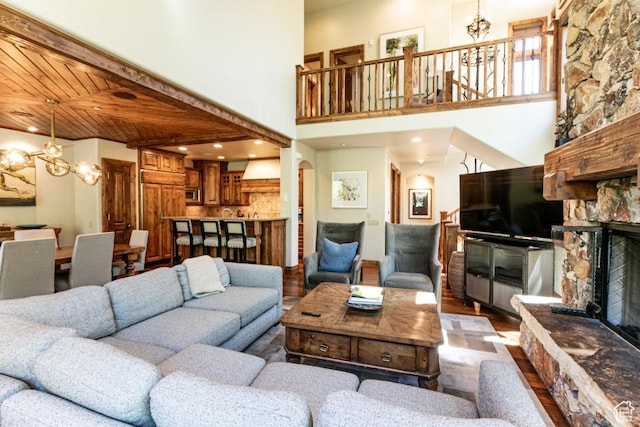 8789 Marsac Ave Unit 4, Park City, UT 84060 - living area with a chandelier, a fireplace, dark wood-type flooring, and a towering ceiling