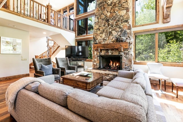 8789 Marsac Ave Unit 4, Park City, UT 84060 - living area with stairway, wood finished floors, a towering ceiling, and a stone fireplace