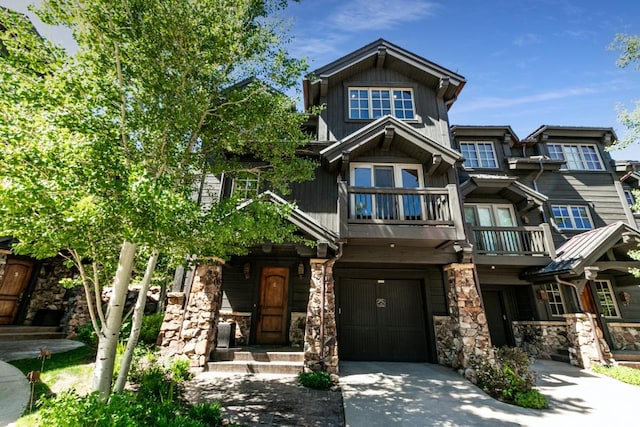 8789 Marsac Ave Unit 4, Park City, UT 84060 - craftsman-style home featuring a balcony, an attached garage, stone siding, and concrete driveway