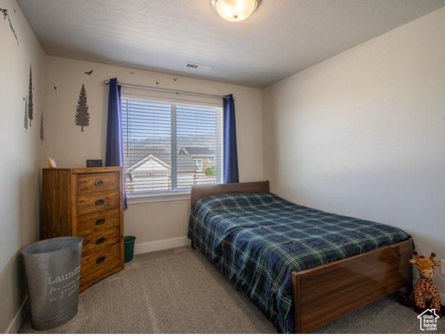 4910 N Deseret Peak Dr, Eagle Mountain, UT 84005 - bedroom with baseboards and carpet