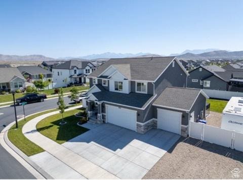 4910 N Deseret Peak Dr, Eagle Mountain, UT 84005 - traditional-style house featuring a residential view, a mountain view, a garage, and driveway