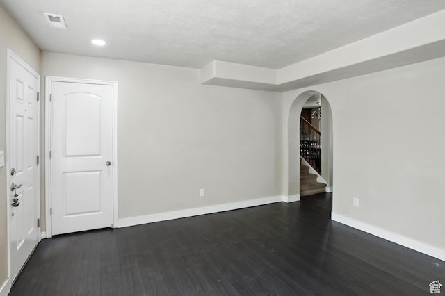 1061 N Bellingham Ct W, North Salt Lake, UT 84054 - empty room featuring arched walkways, dark wood-style flooring, stairs, and recessed lighting