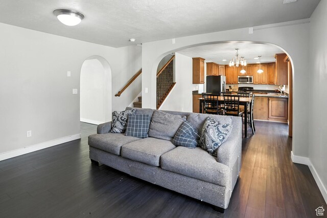 1061 N Bellingham Ct W, North Salt Lake, UT 84054 - living area with arched walkways, a chandelier, dark wood-style floors, and stairway