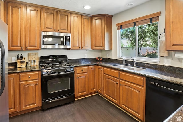 1061 N Bellingham Ct W, North Salt Lake, UT 84054 - kitchen with black appliances, brown cabinets, dark stone counters, and recessed lighting